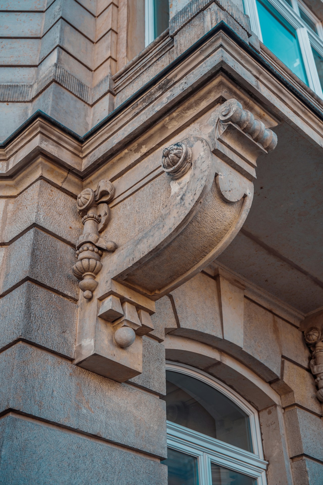 Intricate stone corbels and carved blocks on a historic building facade.